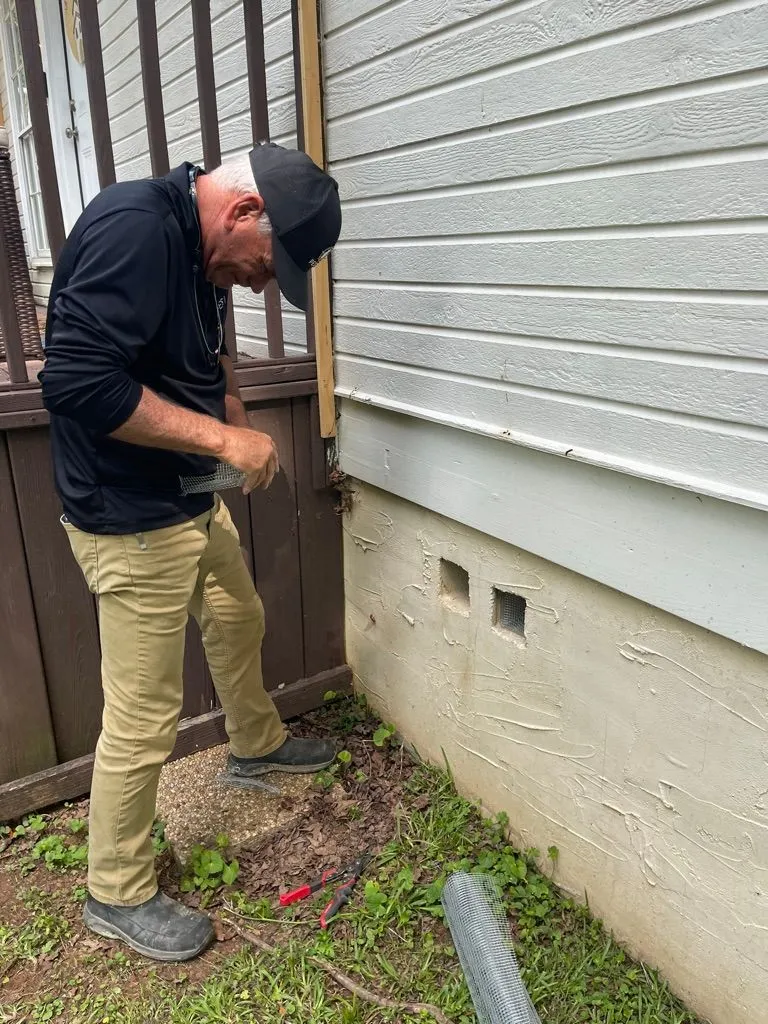 Scott Gilbert working on rodent exclusion at a Sumiton, Alabama home.